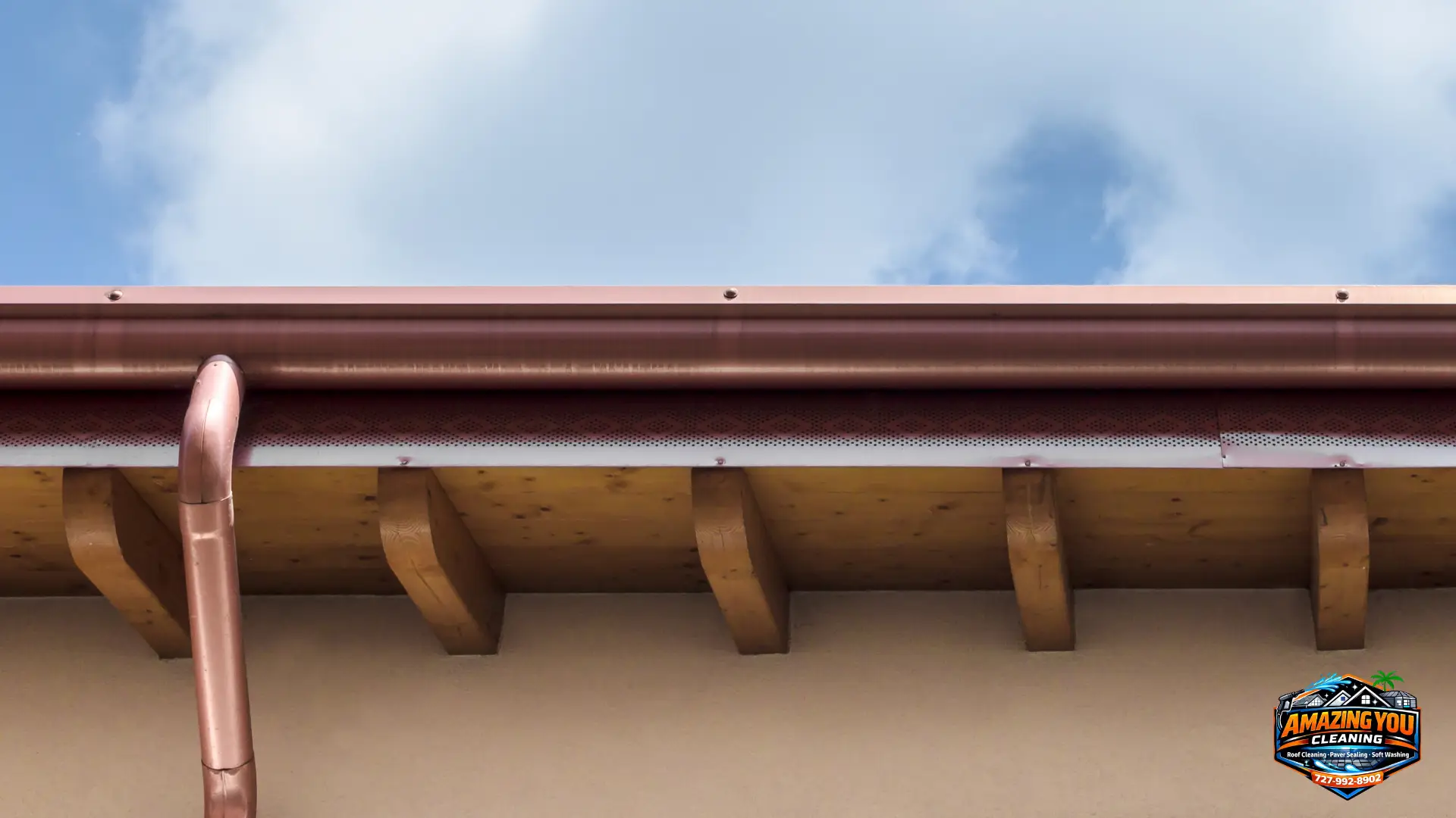 Freshly cleaned copper gutters and downspout on a home — gutter cleaning by Amazing You Cleaning