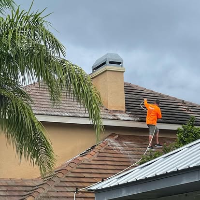 Amazing You Cleaning technician performing a soft wash roof cleaning
